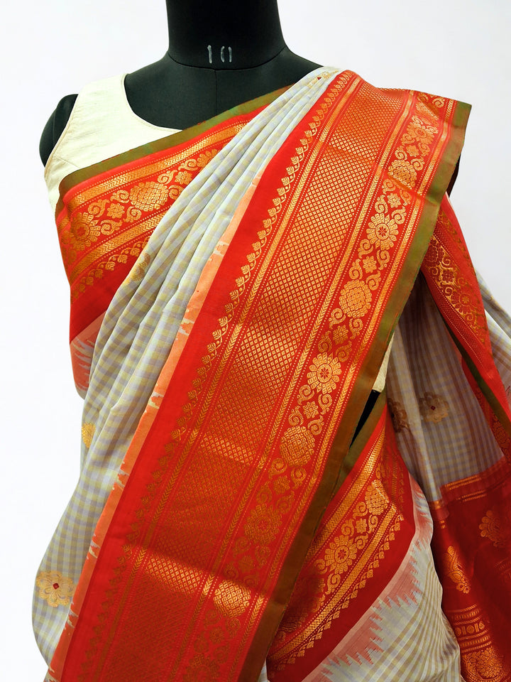 Light grey gadwal silk saree with orange temple border