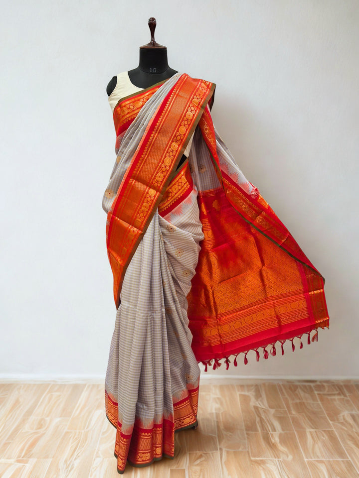 Light grey gadwal silk saree with orange temple border