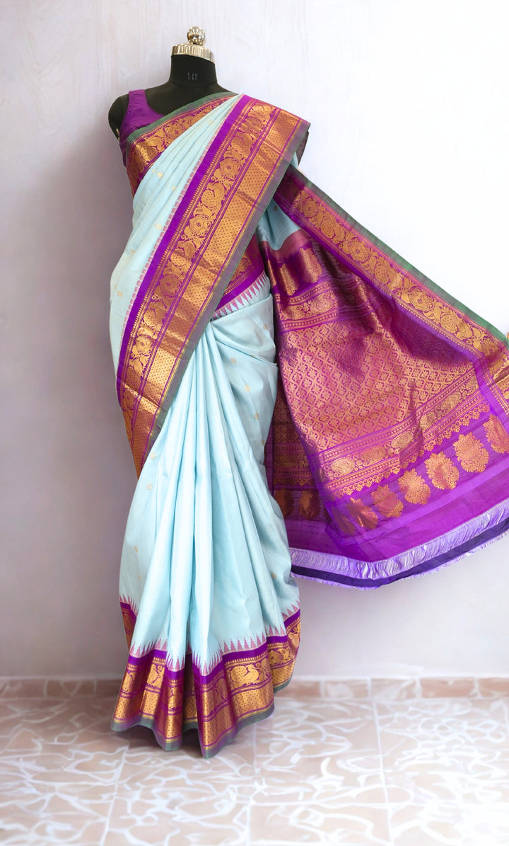Powder blue silk gadwal saree with temple border