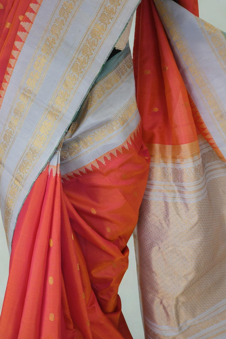 Reddish pink silk gadwal saree with temple border
