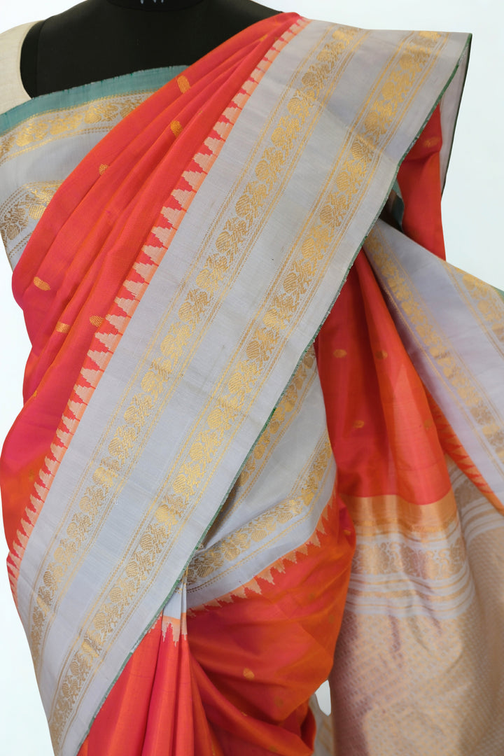 Reddish pink silk gadwal saree with temple border