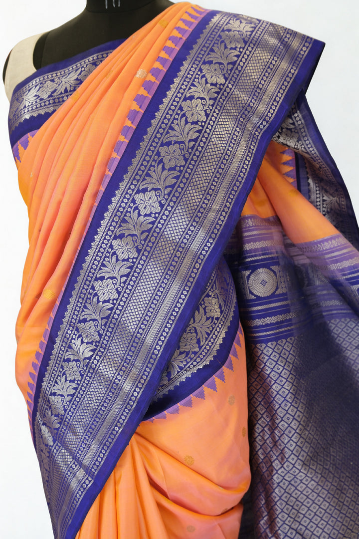 Peach gadwal silk saree with blue temple border