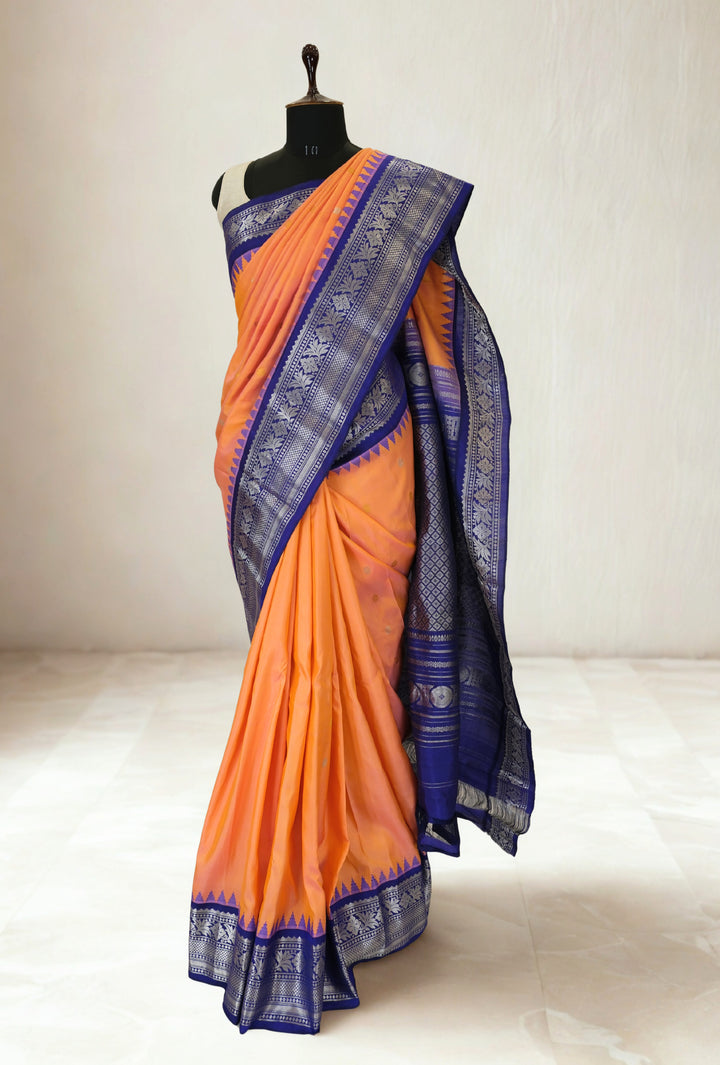 Peach gadwal silk saree with blue temple border