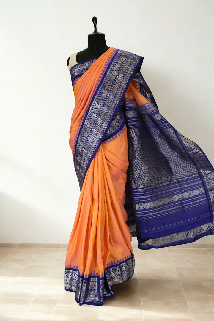 Peach gadwal silk saree with blue temple border