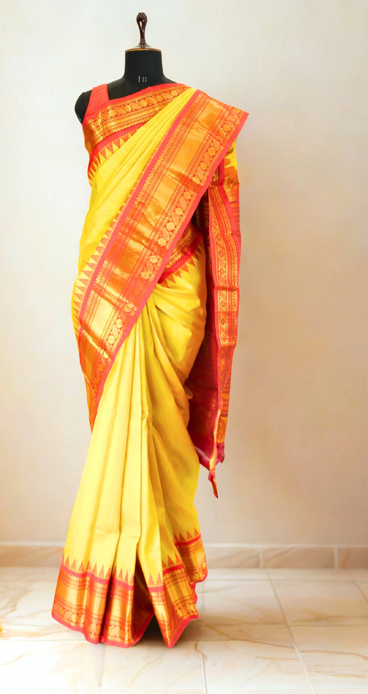 Canary yellow silk gadwal saree with temple border