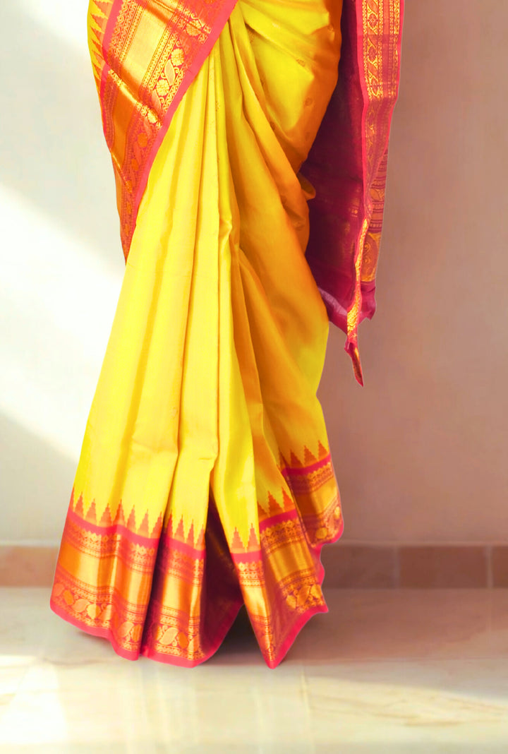 Canary yellow silk gadwal saree with temple border