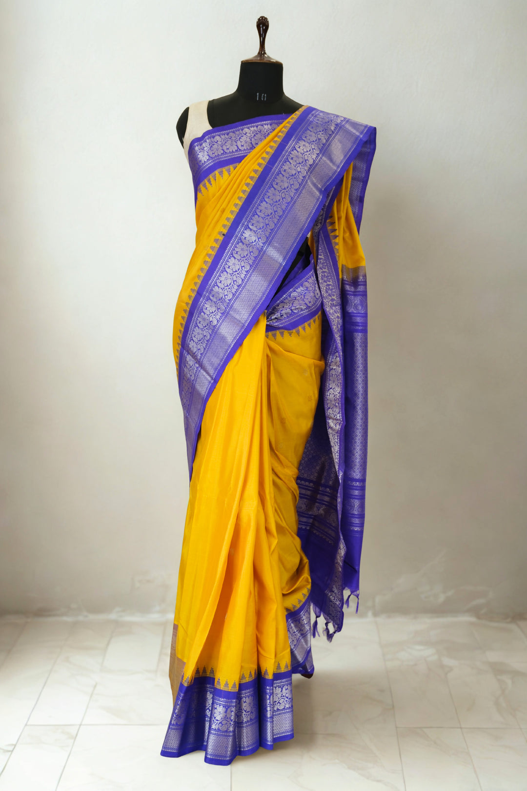 Mustard yellow gadwal silk saree with blue temple border