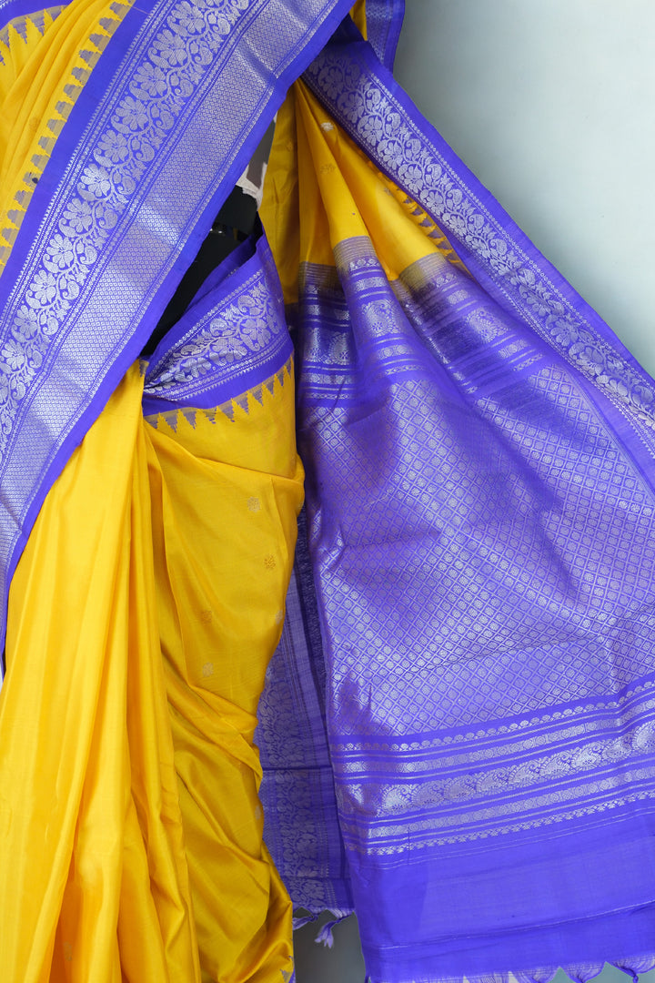 Mustard yellow gadwal silk saree with blue temple border