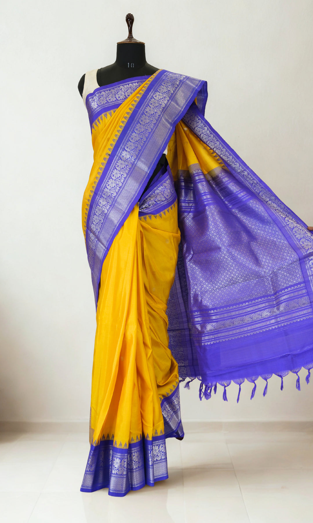 Mustard yellow gadwal silk saree with blue temple border